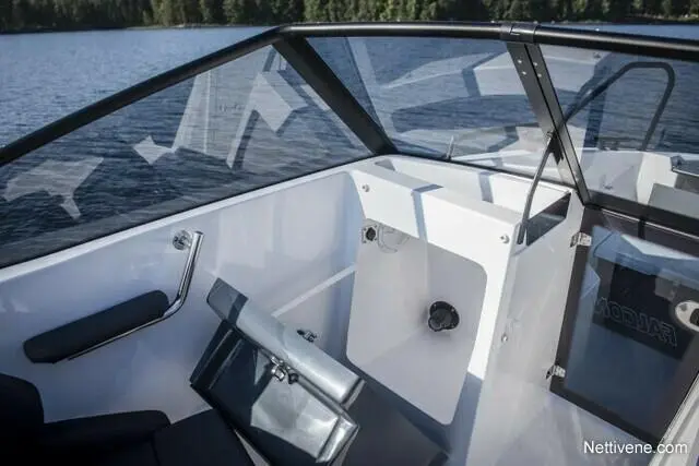 Modern boat interior with a sleek dashboard and seating, overlooking a serene water landscape. Visible text reads "MODULAR.
